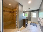 BATHROOM 3 ON THE LOWER LEVEL WITH AN OVERSIZED WALK IN SHOWER & WALKOUT DOOR TO THE LAKESIDE PATIO